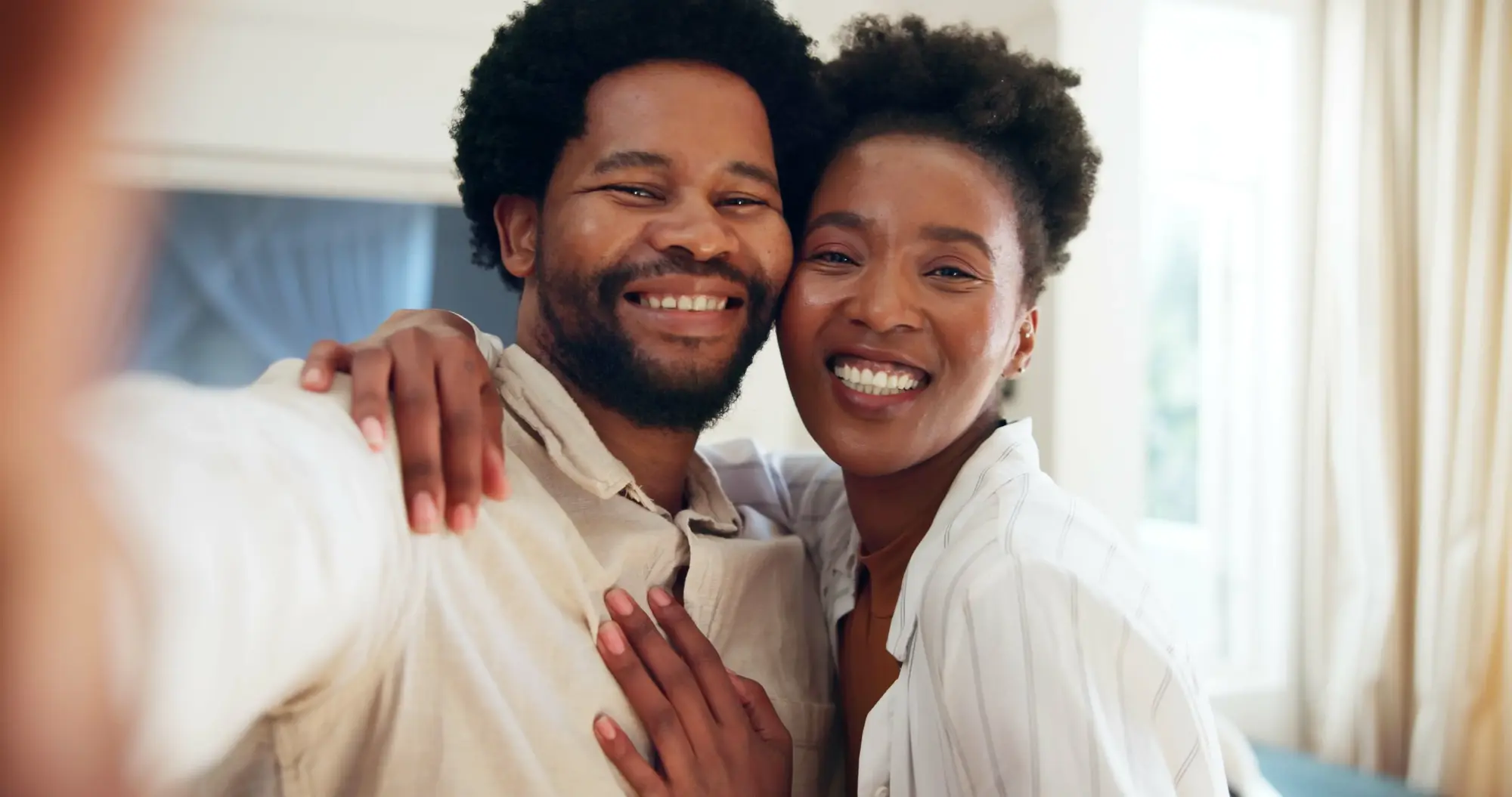 A couple smiling closely together